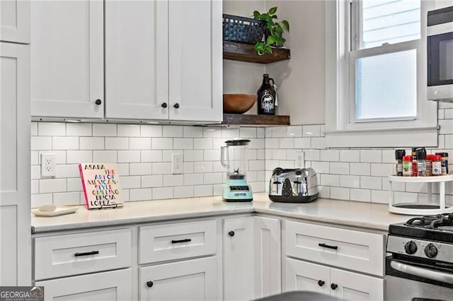 942 Byron Dr SW, Atlanta, GA 30310 - kitchen featuring open shelves, white cabinetry, stainless steel microwave, and light countertops