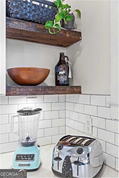 interior details featuring light countertops and backsplash