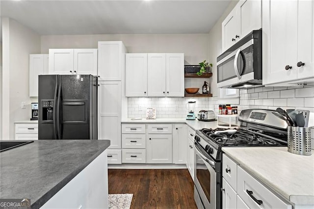 kitchen featuring open shelves, stainless steel appliances, decorative backsplash, dark wood-type flooring, and white cabinetry