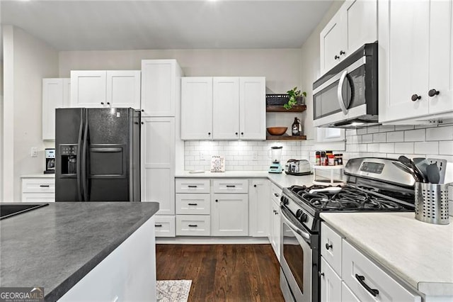 942 Byron Dr SW, Atlanta, GA 30310 - kitchen with stainless steel appliances, open shelves, white cabinetry, dark wood-style floors, and decorative backsplash