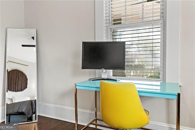 office with a healthy amount of sunlight, baseboards, and wood finished floors