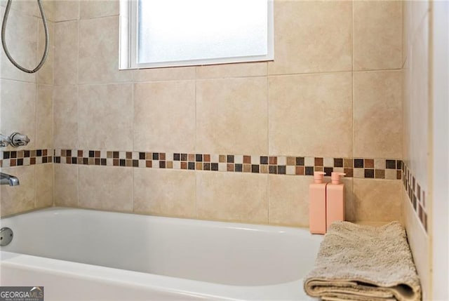 bathroom featuring a washtub and walk in shower