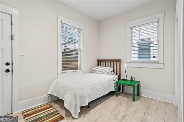 bedroom with multiple windows and baseboards