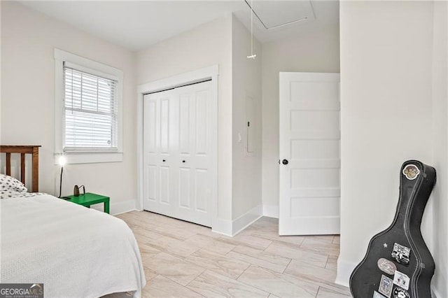 bedroom with baseboards and a closet