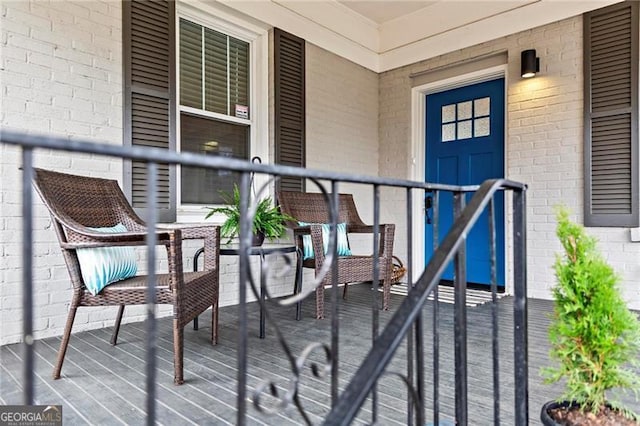 entrance to property featuring brick siding