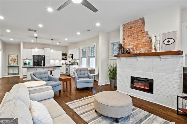 942 Byron Dr SW, Atlanta, GA 30310 - living room featuring a ceiling fan, a brick fireplace, dark wood-style flooring, baseboards, and recessed lighting