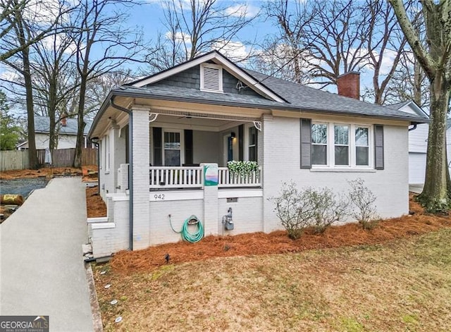 942 Byron Dr SW, Atlanta, GA 30310 - view of front of property with covered porch, a chimney, brick siding, and a shingled roof