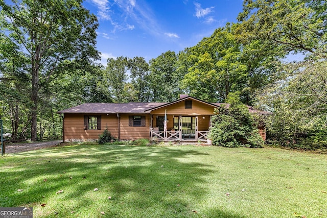 ranch-style house with a porch and a front yard