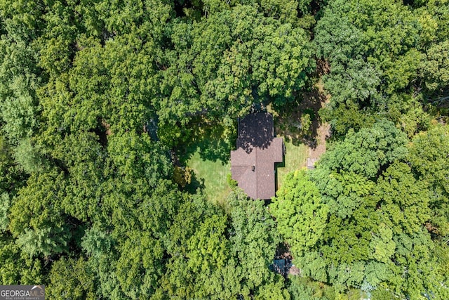 bird's eye view featuring a wooded view