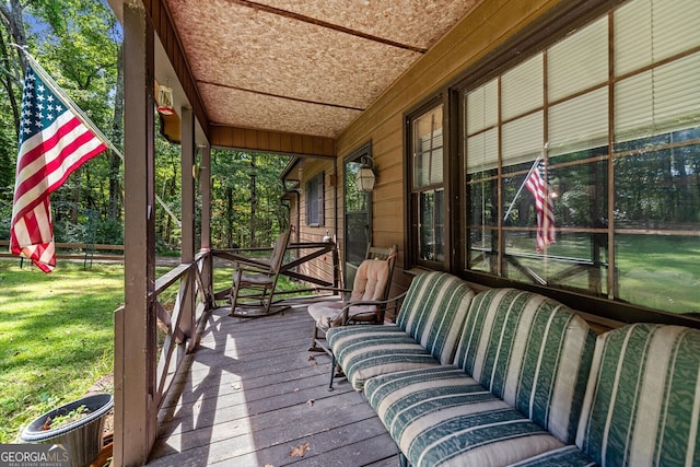 wooden terrace featuring a yard