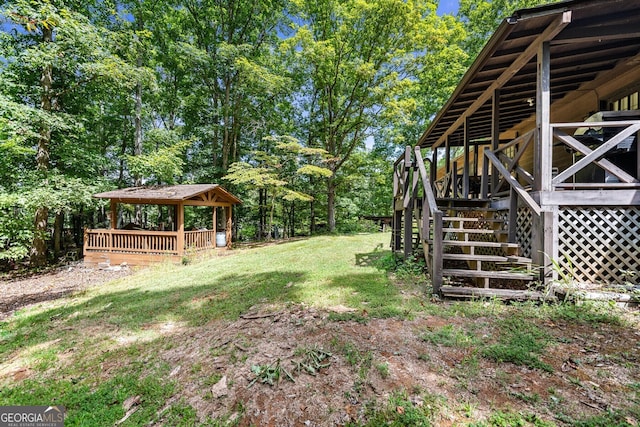 view of yard with a wooden deck, stairs, and a gazebo