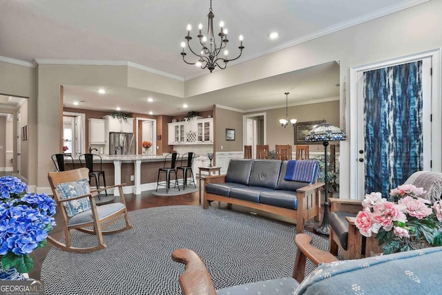 living room with ornamental molding, dark wood-style flooring, recessed lighting, and a notable chandelier