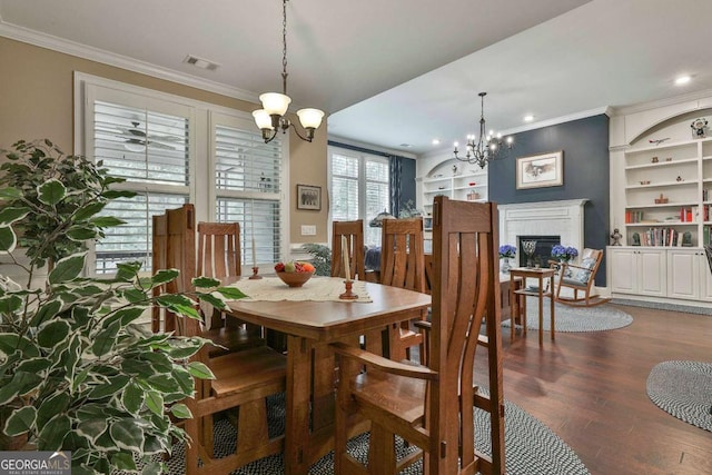 dining area with ornamental molding, a fireplace, and a notable chandelier