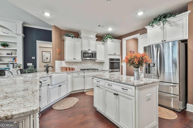 kitchen with white cabinetry, stainless steel appliances, and a sink