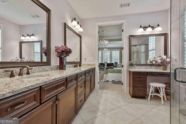 bathroom with double vanity, a stall shower, visible vents, and a sink