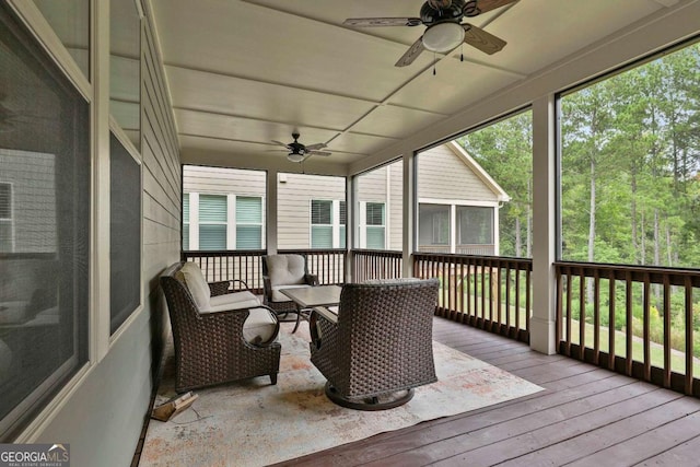 sunroom / solarium featuring a healthy amount of sunlight and a ceiling fan