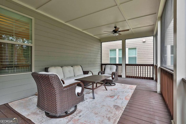 sunroom / solarium featuring ceiling fan and coffered ceiling