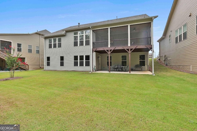 back of property featuring a sunroom, a lawn, and a patio