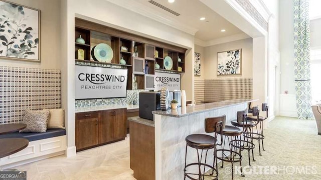 bar with recessed lighting, visible vents, crown molding, and a bar