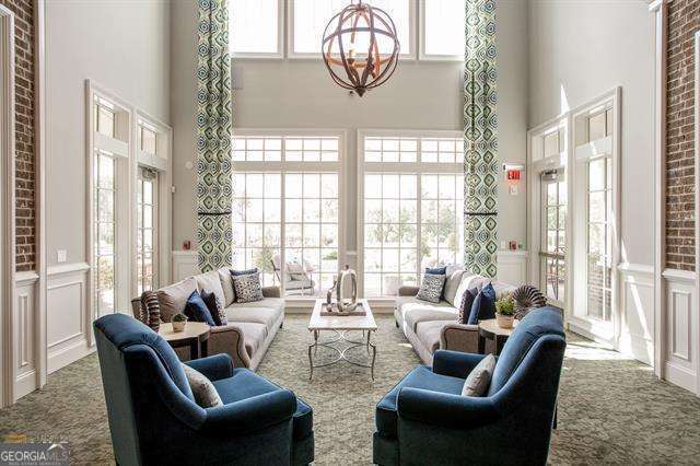 sunroom featuring a wealth of natural light and a notable chandelier