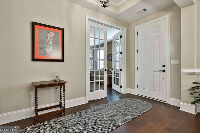 foyer entrance with french doors, visible vents, baseboards, and wood finished floors