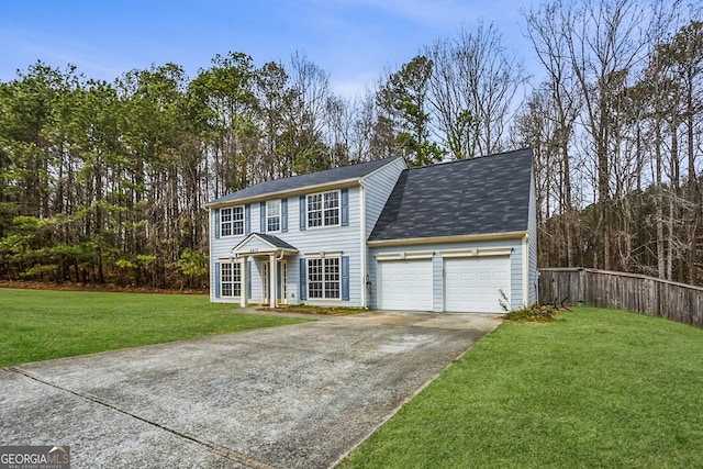 view of front of property with driveway, an attached garage, a front yard, and fence