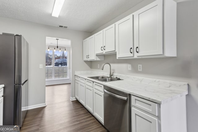 kitchen with visible vents, appliances with stainless steel finishes, white cabinetry, and a sink