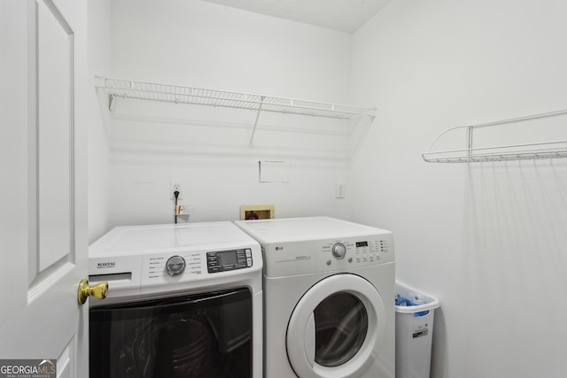 washroom featuring laundry area and washer and clothes dryer