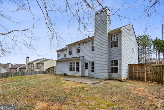 rear view of property with a patio area, a fenced backyard, and a chimney