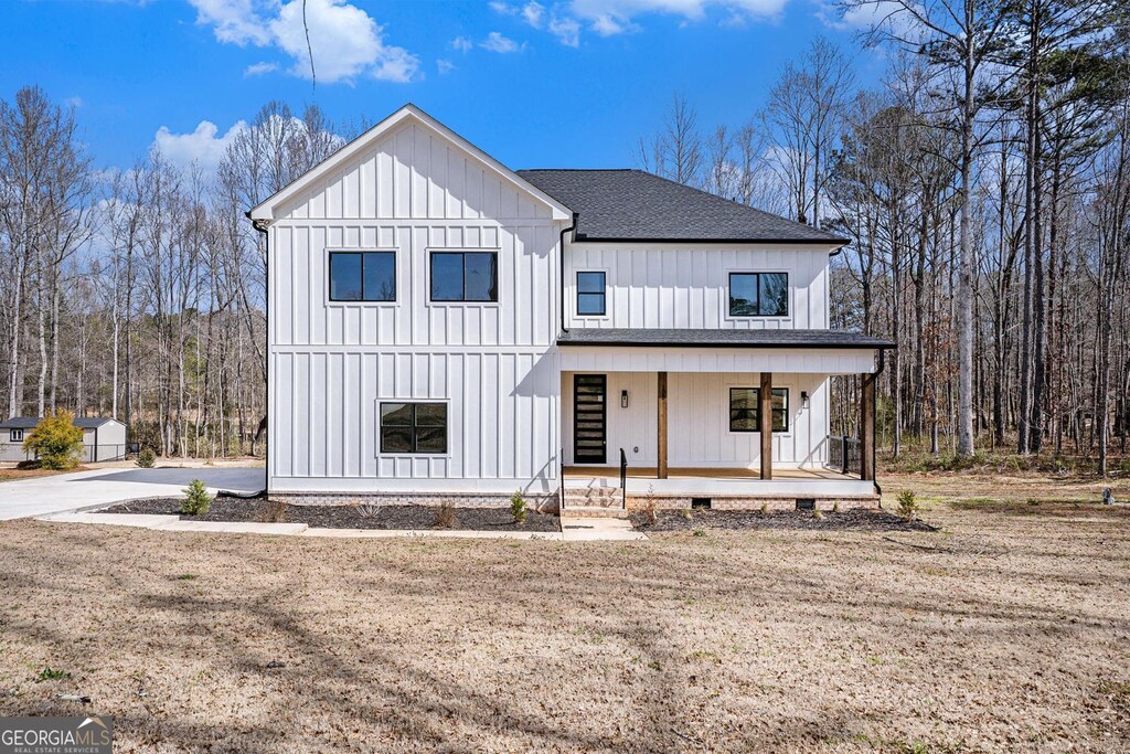 view of front of house featuring a porch, roof with shingles, and board and batten siding