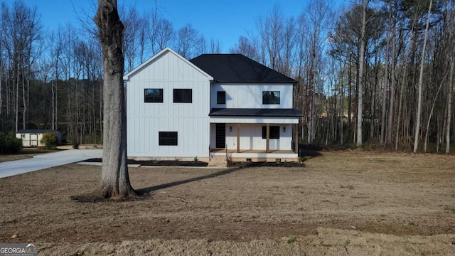 view of front of house featuring a porch, roof with shingles, and board and batten siding