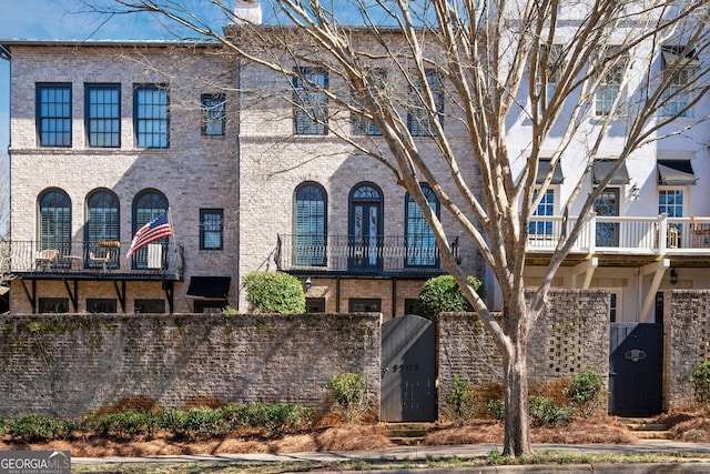 view of front of home featuring a fenced front yard and brick siding