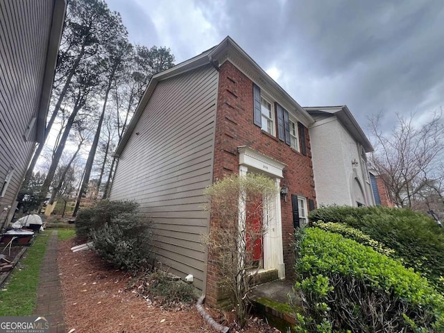 view of side of property with brick siding