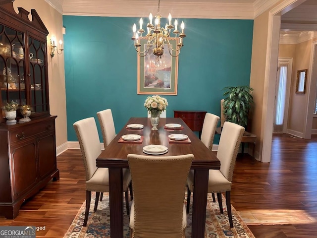 dining area with ornamental molding, a chandelier, baseboards, and wood finished floors