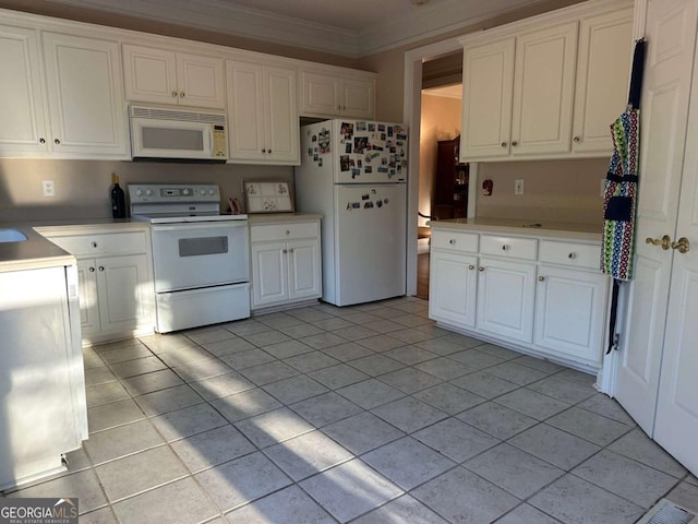 kitchen featuring light tile patterned floors, white appliances, white cabinetry, and crown molding