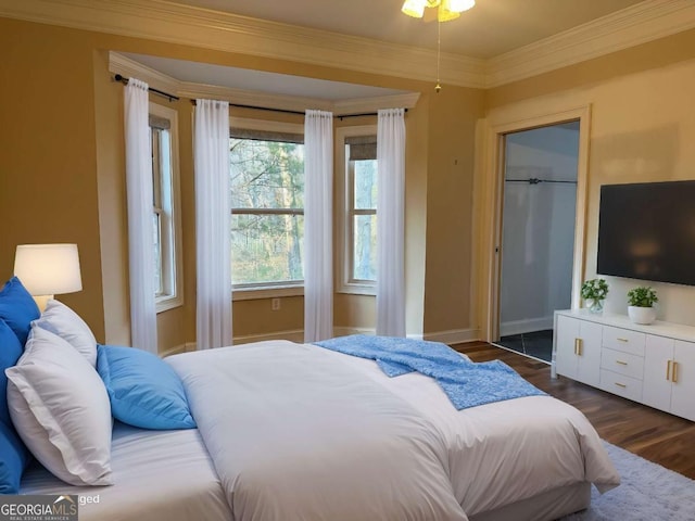 bedroom featuring crown molding, baseboards, and dark wood-style flooring