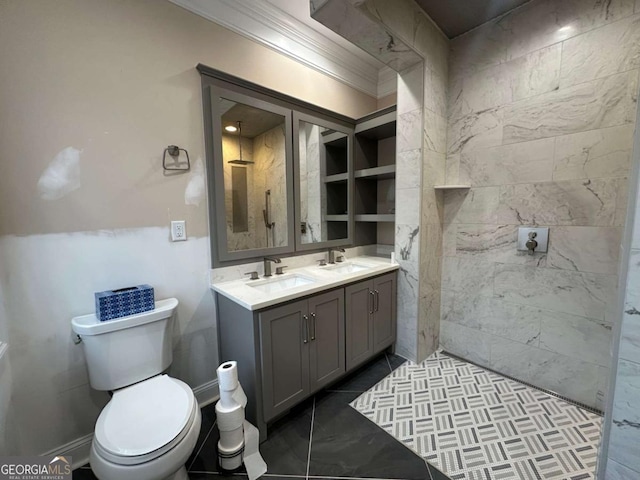 bathroom with toilet, double vanity, a tile shower, and a sink