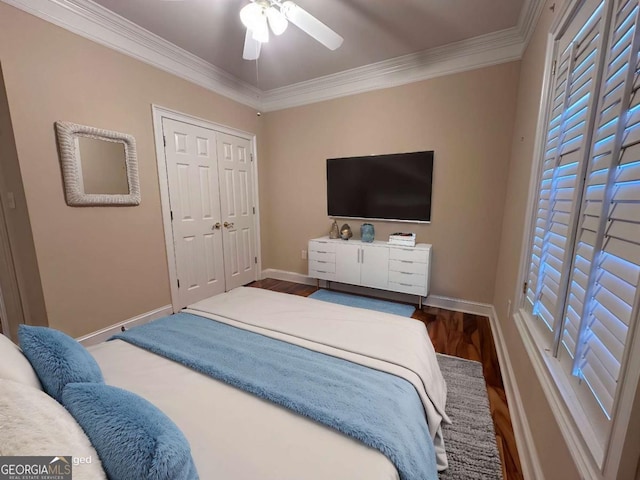 bedroom with ornamental molding, baseboards, and wood finished floors