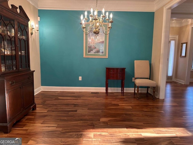 living area with ornamental molding, a notable chandelier, baseboards, and wood finished floors