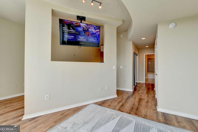 interior space with recessed lighting, baseboards, and wood finished floors