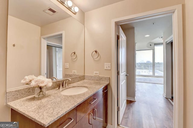 bathroom featuring visible vents, wood finished floors, and vanity