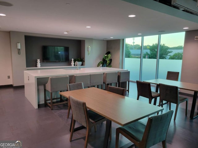 dining space featuring expansive windows, baseboards, and recessed lighting