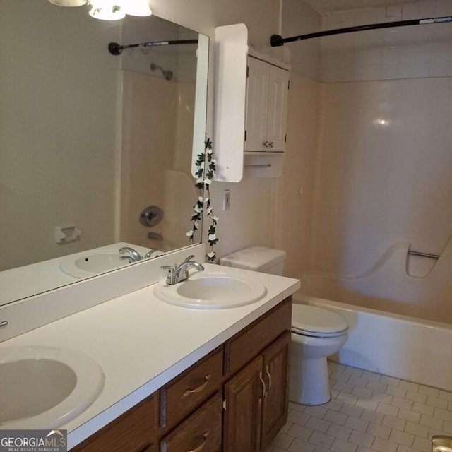 full bath with toilet, tile patterned flooring, and a sink