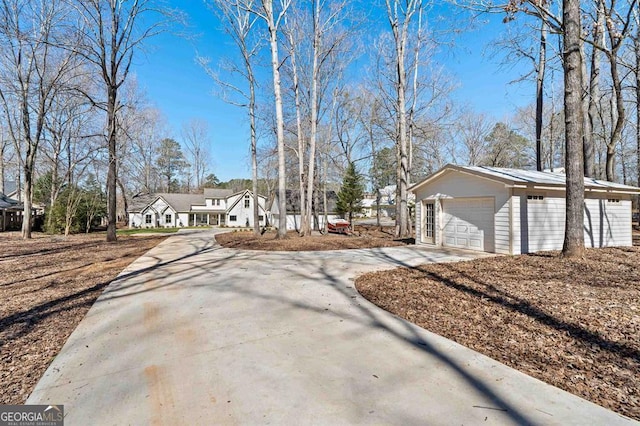 view of front of property featuring an outbuilding and concrete driveway