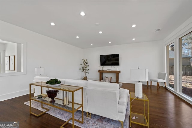 living room with baseboards, wood finished floors, visible vents, and recessed lighting