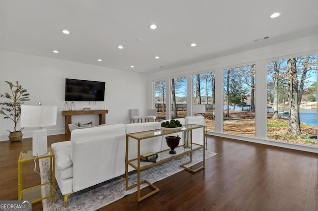 living room featuring wood finished floors, visible vents, and recessed lighting