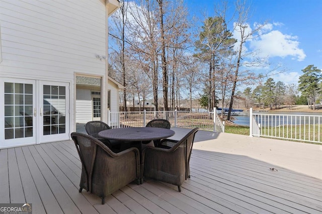 wooden terrace featuring french doors and outdoor dining area