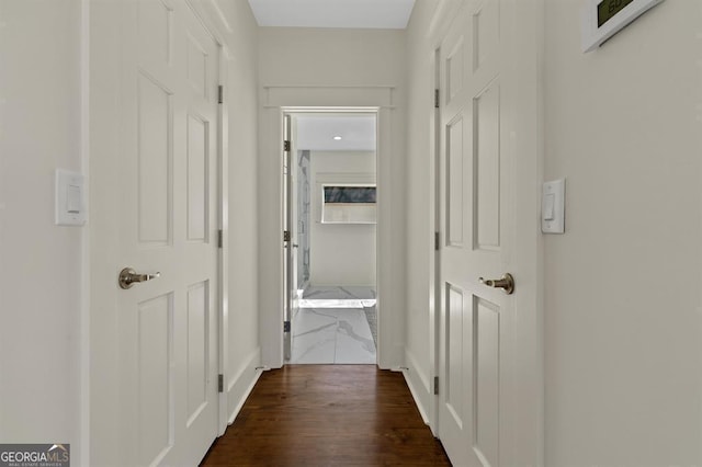 corridor featuring dark wood-style flooring