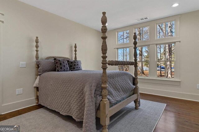 bedroom featuring recessed lighting, wood finished floors, visible vents, and baseboards