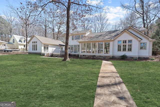 view of front of house featuring crawl space, a sunroom, and a front yard